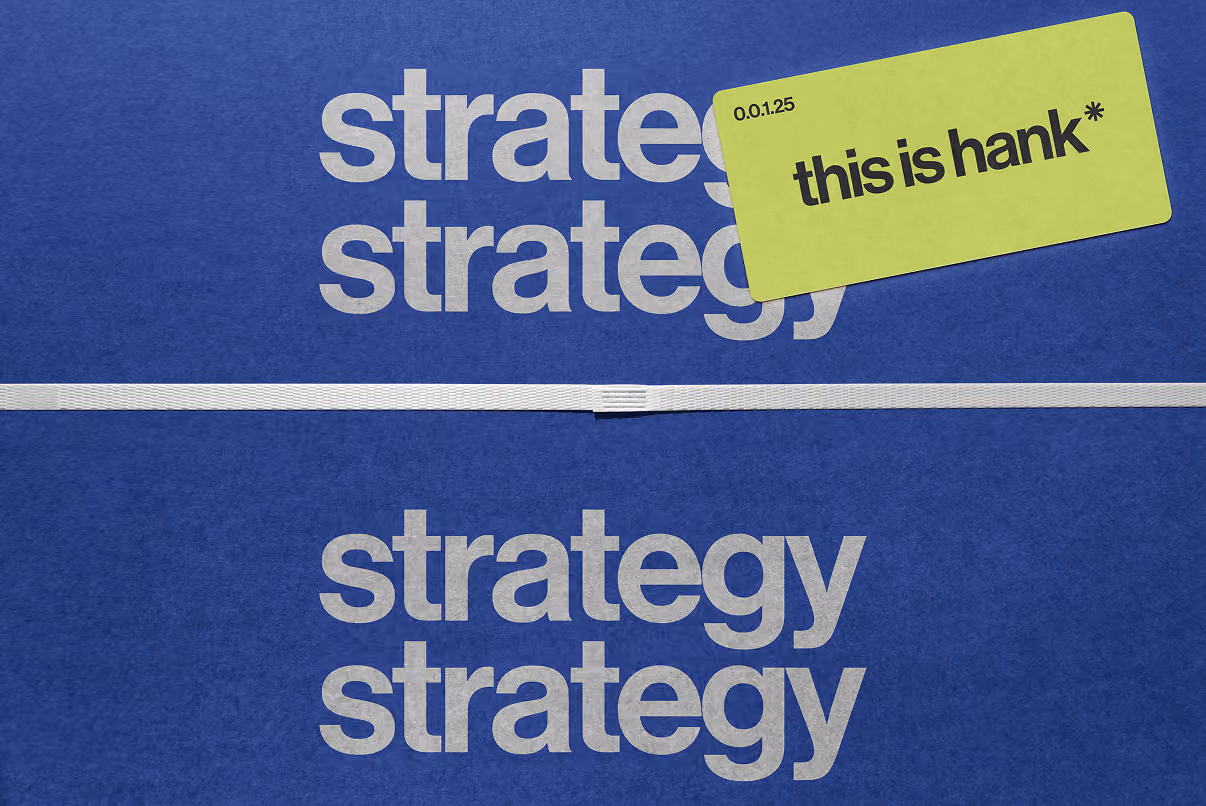 Blue background with the word 'strategy' repeated four times in large white lowercase letters, divided by a white horizontal strap, and a green card in the upper right corner with the text 'this is hank*' and a small numeric code.