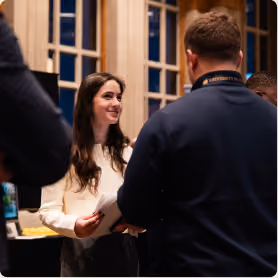 Encore team and partners gathering at an indoor networking event.
