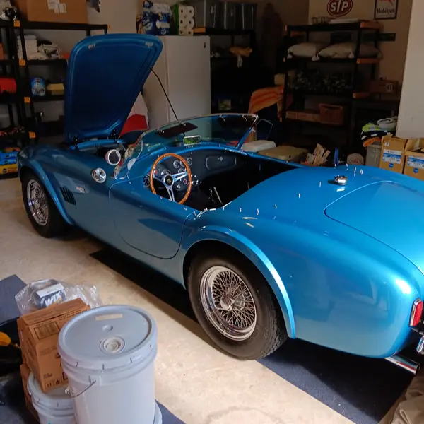 Blue Shelby Cobra roadster replica in a garage during a specialty vehicle appraisal