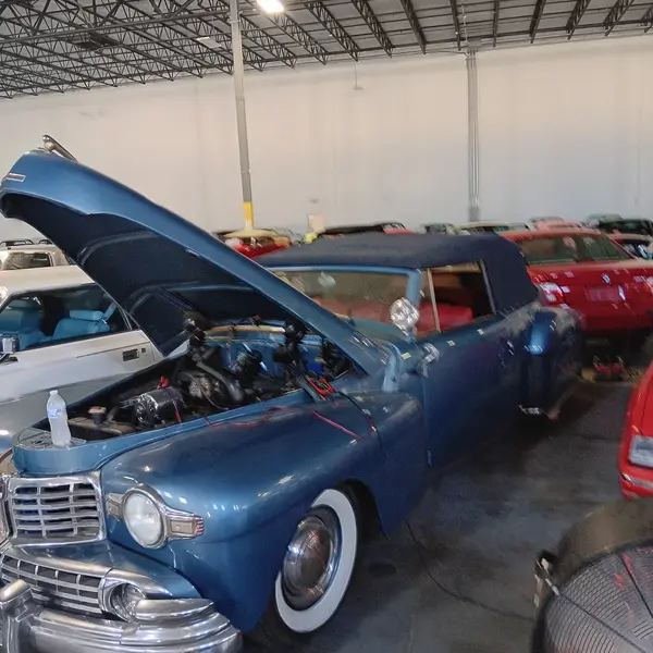 Classic Lincoln Continental convertible with hood raised during a pre-purchase inspection