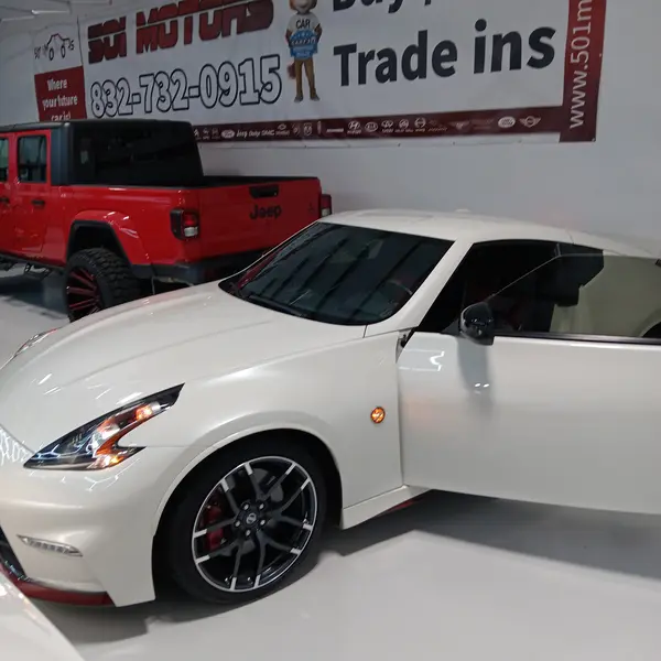 White Nissan 370Z Nismo sports car appraised at a Texas dealership