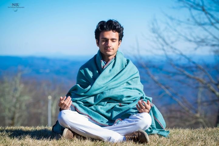 Person practicing SKY Breath Meditation outdoors for anxiety relief