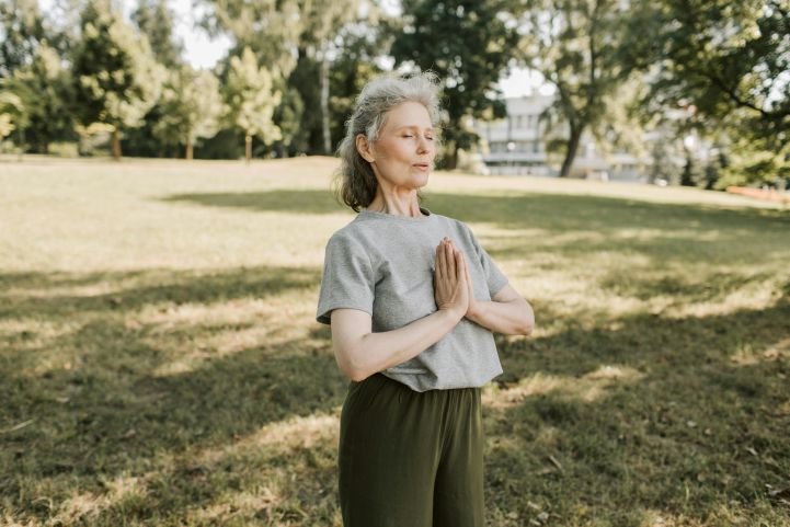 a woman taking a few moments of deep breaths