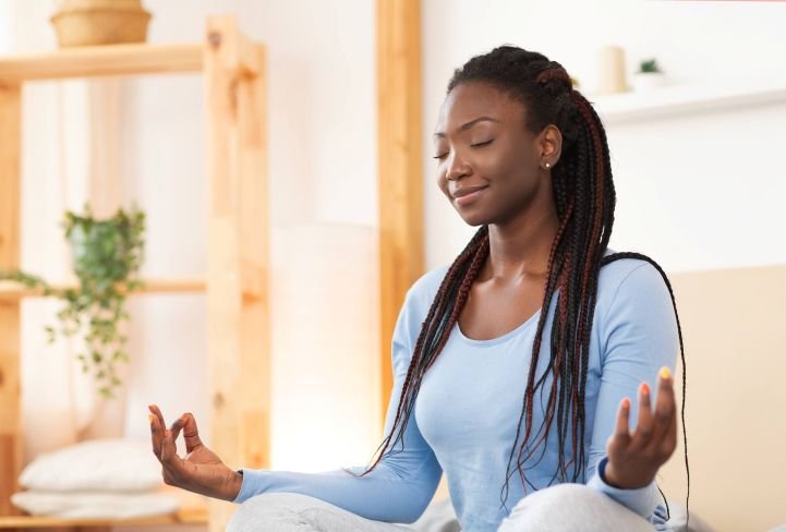 A woman with a serene expression while practicing SKY Breath Meditation.