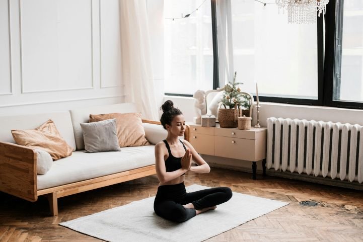 A woman practicing SKY at home for quick rejuvenation.