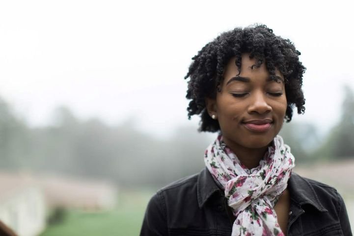 A young woman in a deep state of relaxation during a SKY Breath Meditation practice.