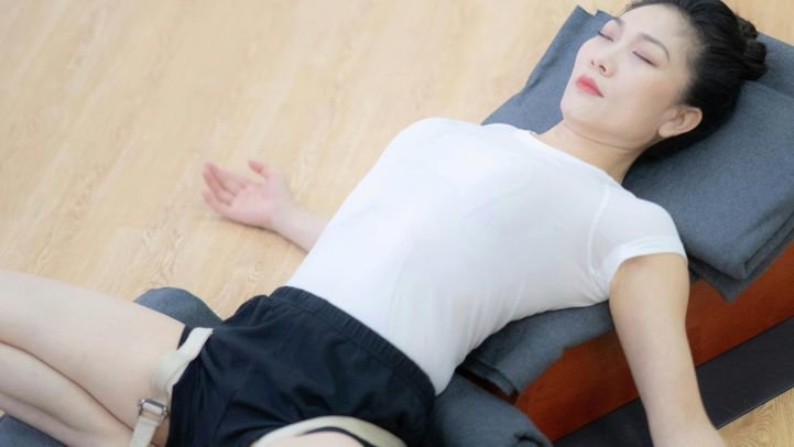 A woman focusing on the breath while releasing tension.