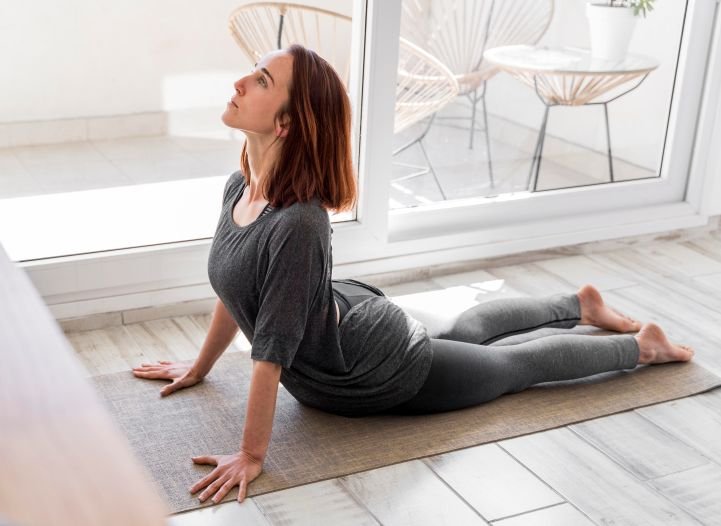 A woman doing a restorative yoga practice.