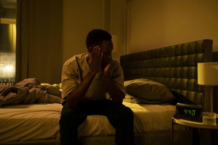 Man awake in the middle of night with insomnia symptoms.