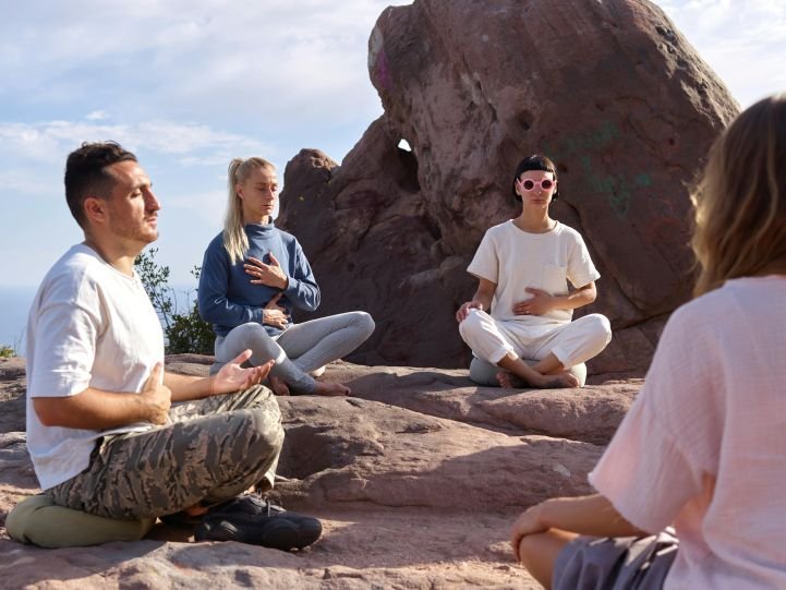 A group practicing breathwork outdoors.