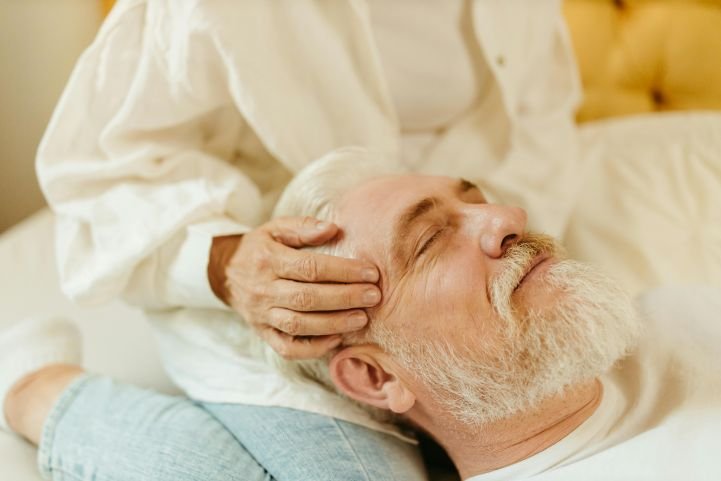 An older couple practicing marma at home.
