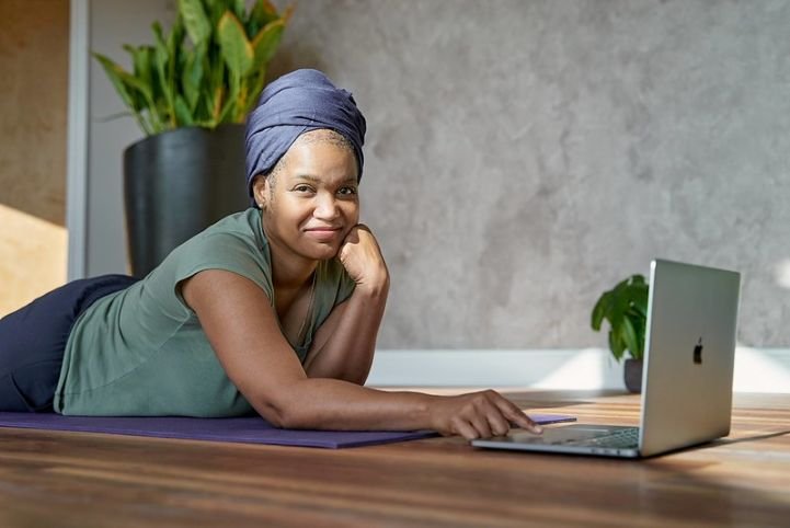 Calm woman using AI to research breathwork on her laptop.