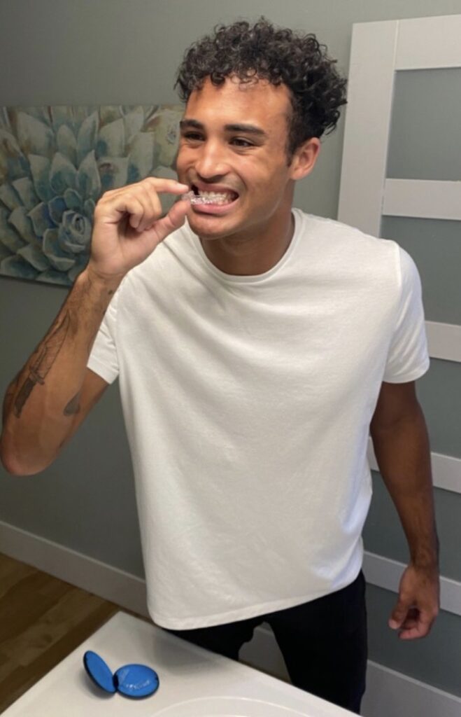 A patient getting ready to clean the invisalign