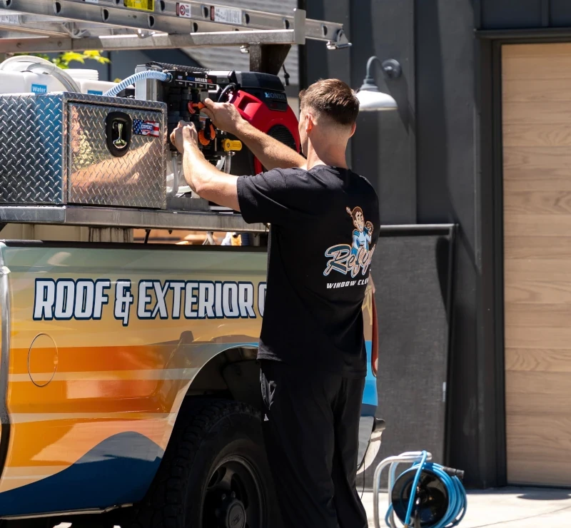 Refyne technician adjusting pressure washing equipment mounted
