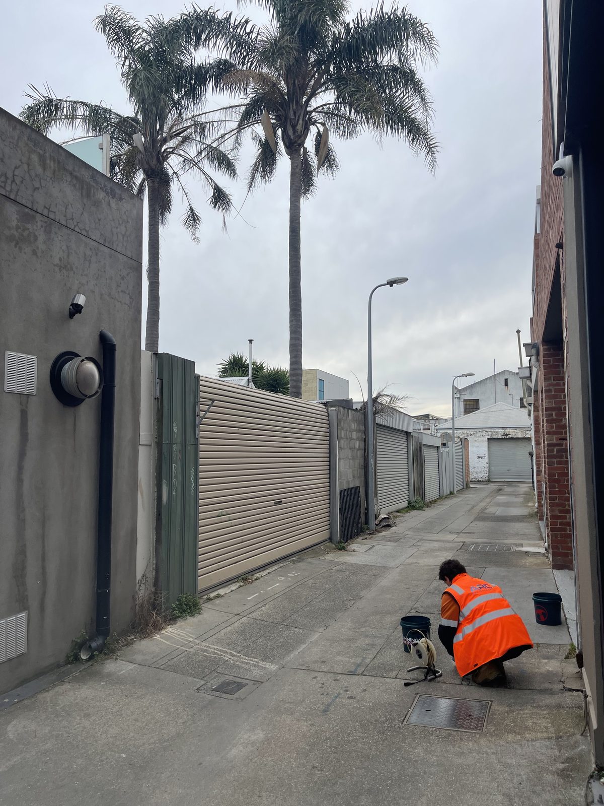 Consultant sampling in a laneway beside the former dry cleaning site