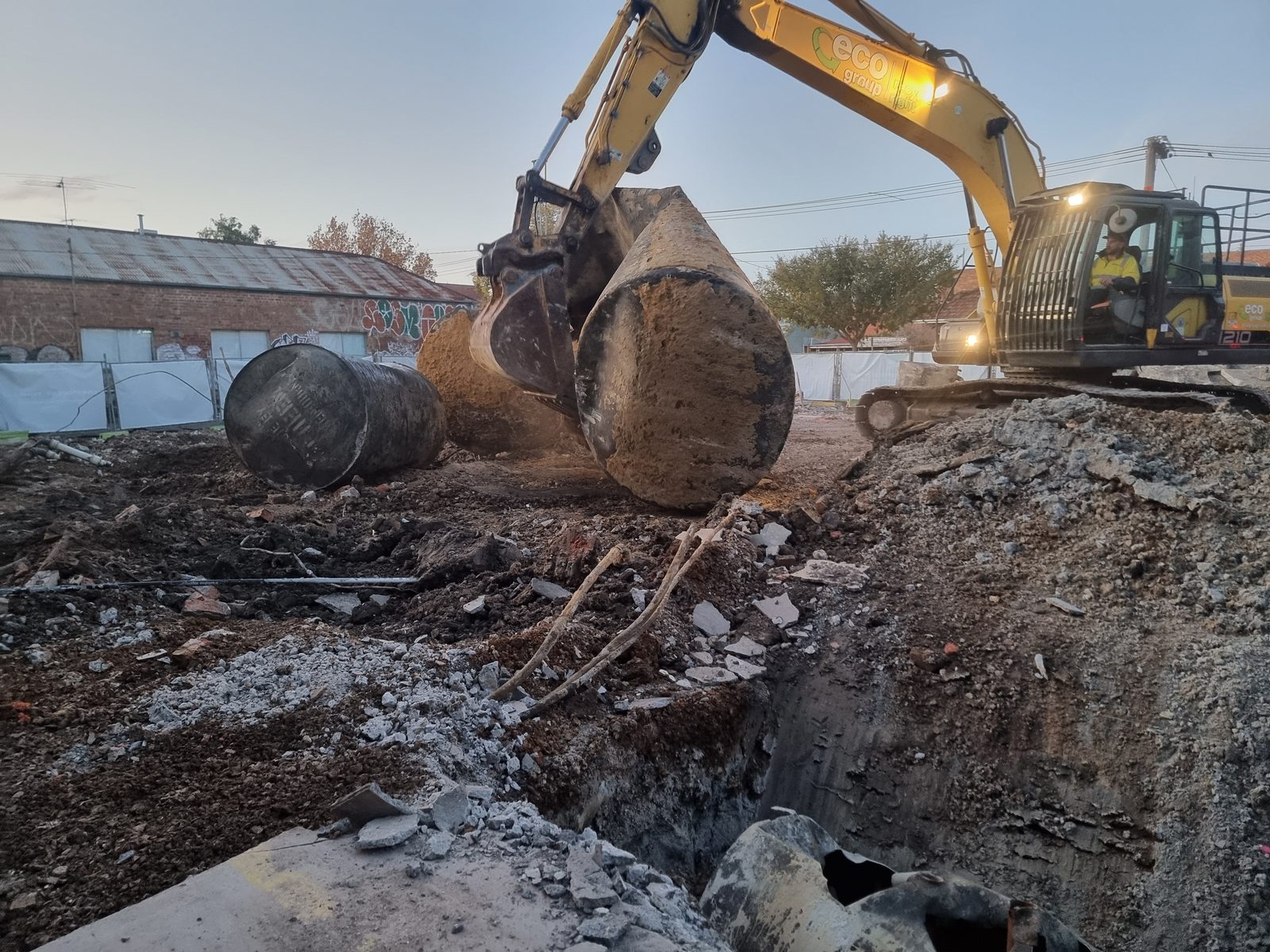 Excavator removing an underground storage tank