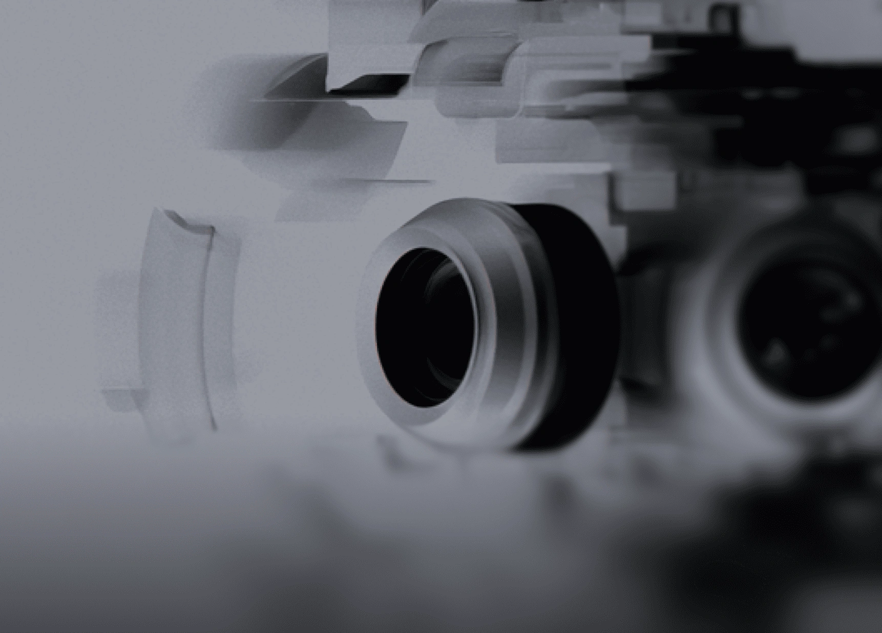 Close-up of a camera lens with abstract geometric shapes in gray tones.