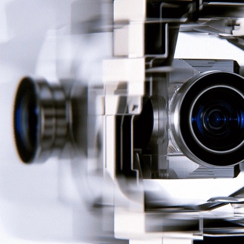 Close-up of a mechanical device with lenses and reflective surfaces, likely a camera or projector part.