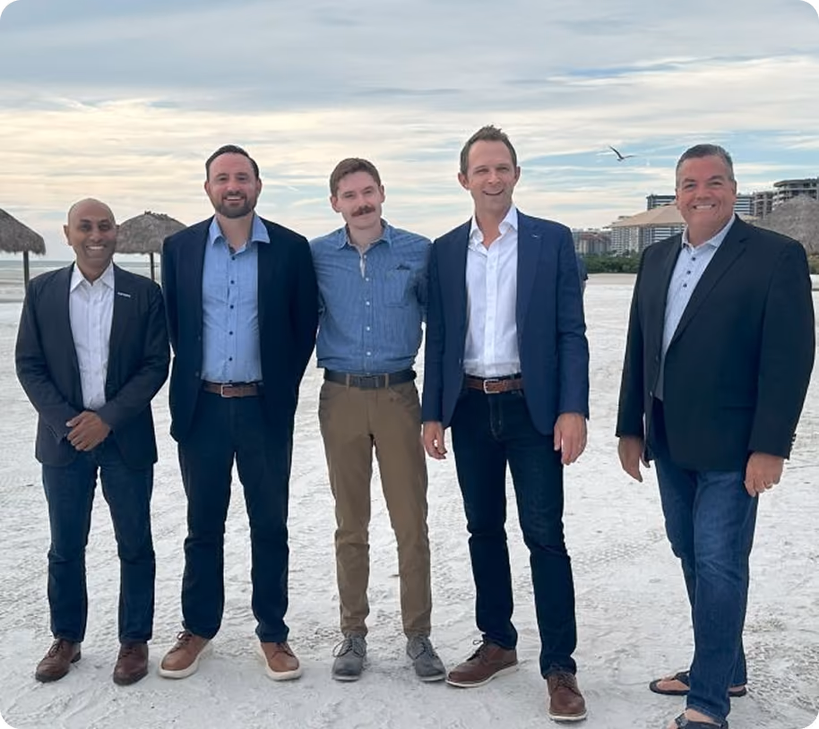 Team members posing together outdoors
