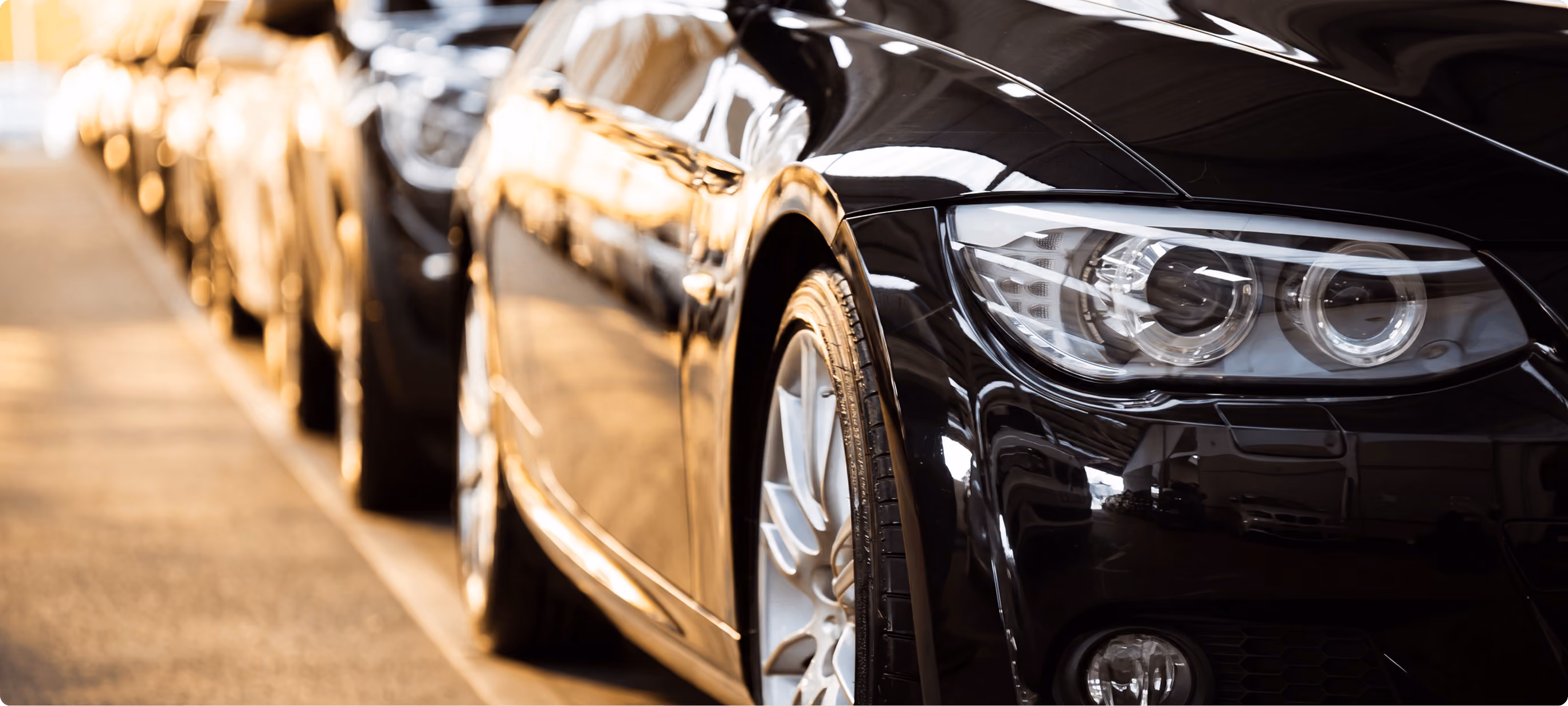 Row of black cars parked in a line