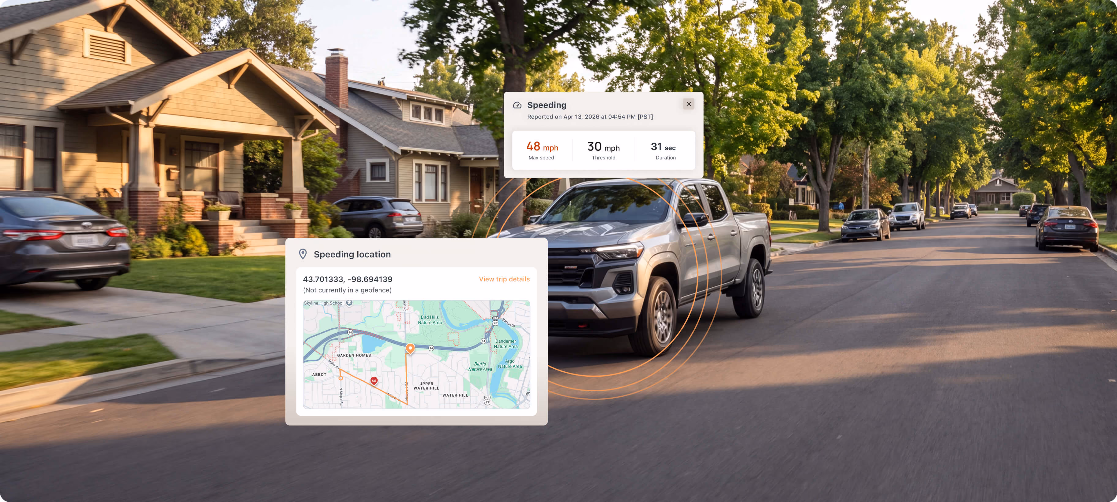 Residential street with a pickup truck and a Motorq dashboard location overlay