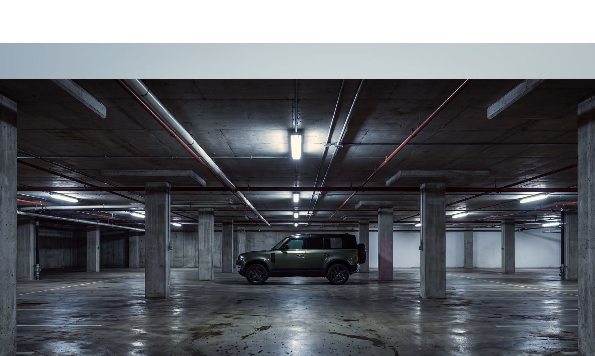 Car parked in a dimly lit underground parking garage