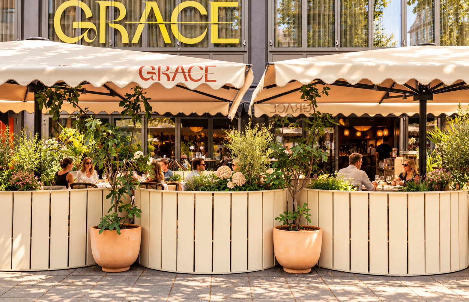 Terras van Grace in Rotterdam: lichte, op maat gemaakte plantenbakken die overgaan in de zitbanken, met terracotta potten en boompjes onder crèmekleurige parasols met het Grace-logo