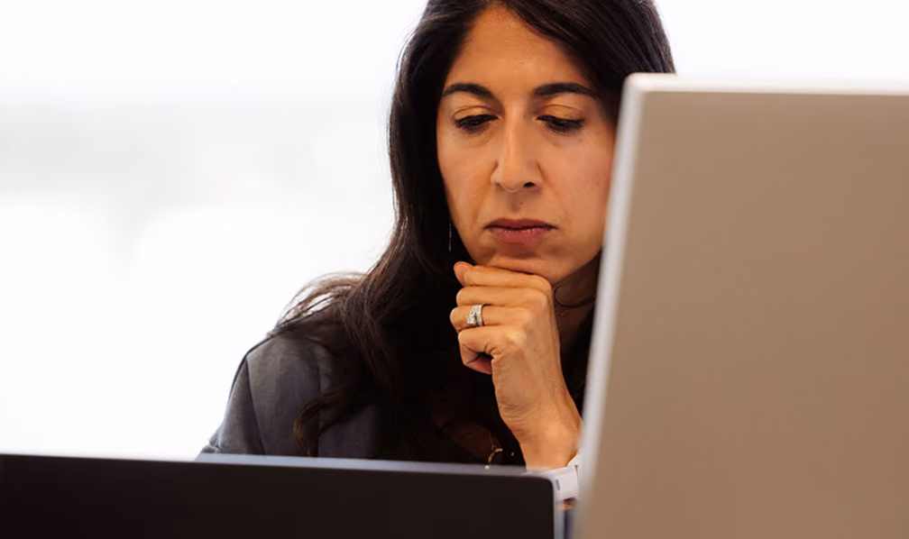 Person working at a desk in front of a monitor
