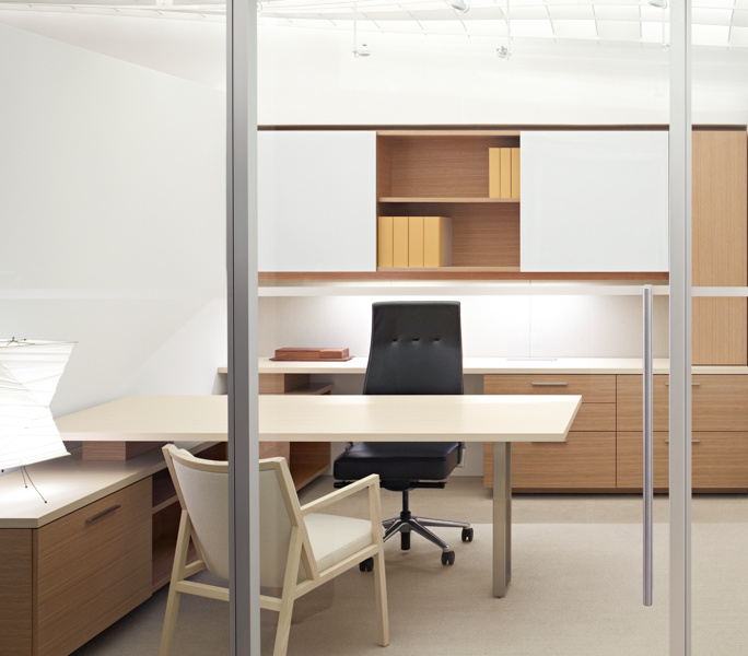 A refined private office integrating backpainted glass surfaces with a coordinated sliding door system.