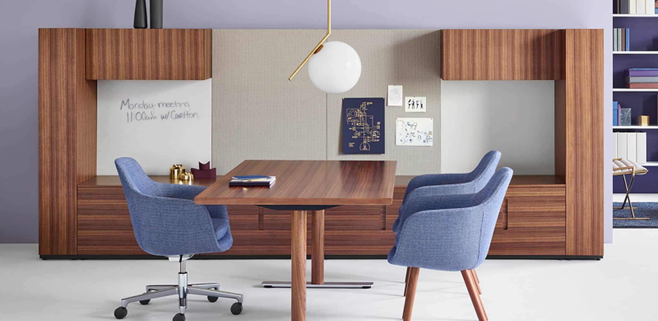 A warm executive office centered on custom backpainted glass cabinetry and a tailored meeting area.