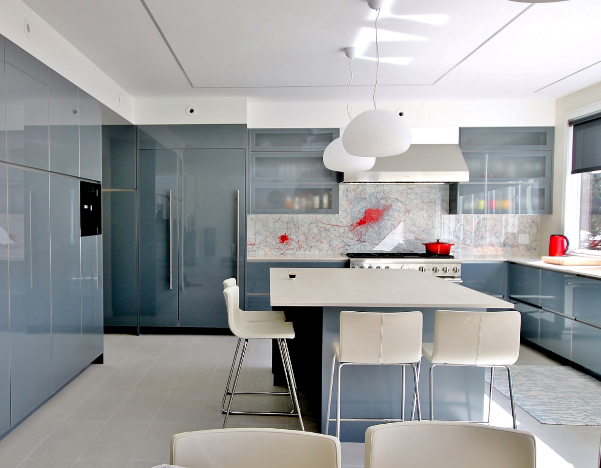 An artistic kitchen featuring custom backpainted glass doors and drawer fronts.