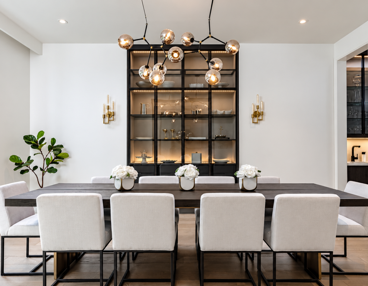 Modern luxury dining room featuring black aluminum frame glass display cabinets with integrated LED lighting, contemporary furnishings, and elegant architectural details.