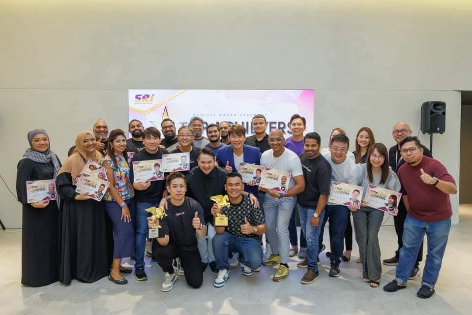 SRI salespeople holding certificates at the monthly Top Achievers ceremony