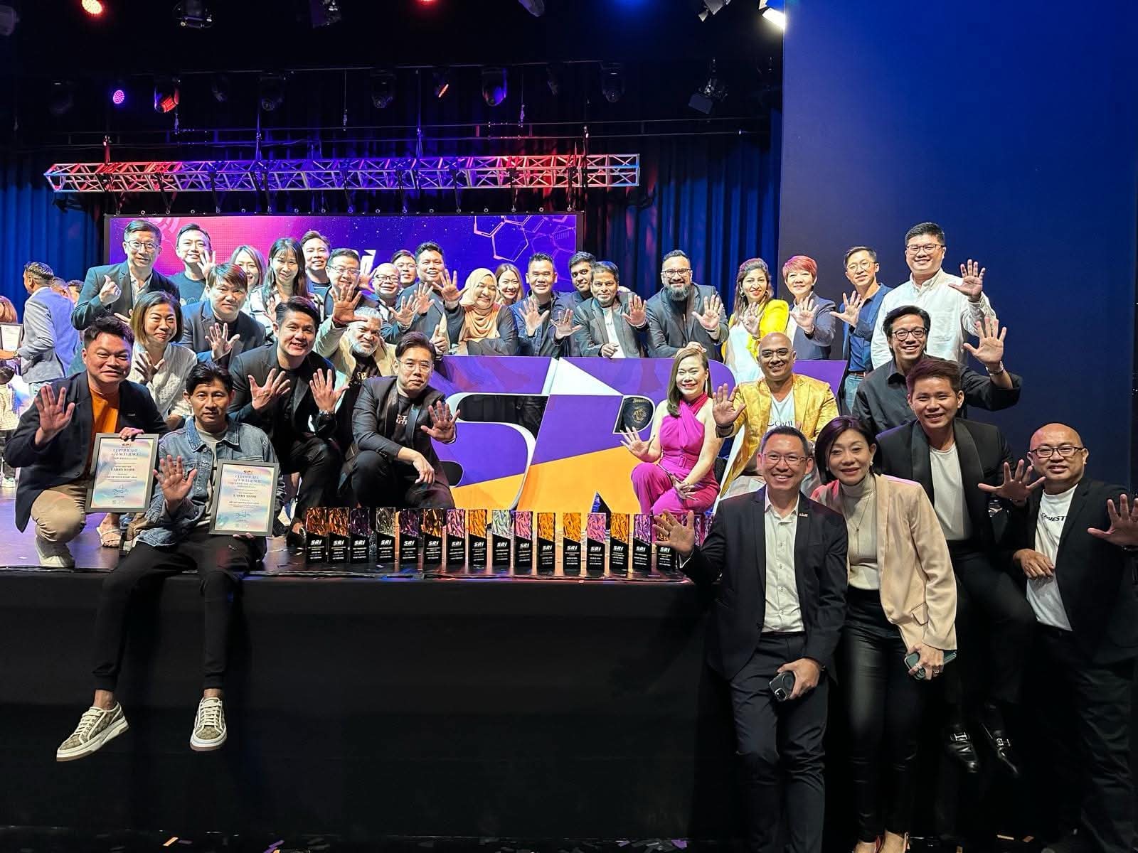 SRI salespeople on stage at the annual awards ceremony