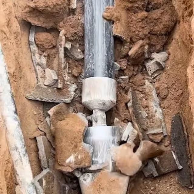 Underground pipe joint exposed during sewer line repair excavation.