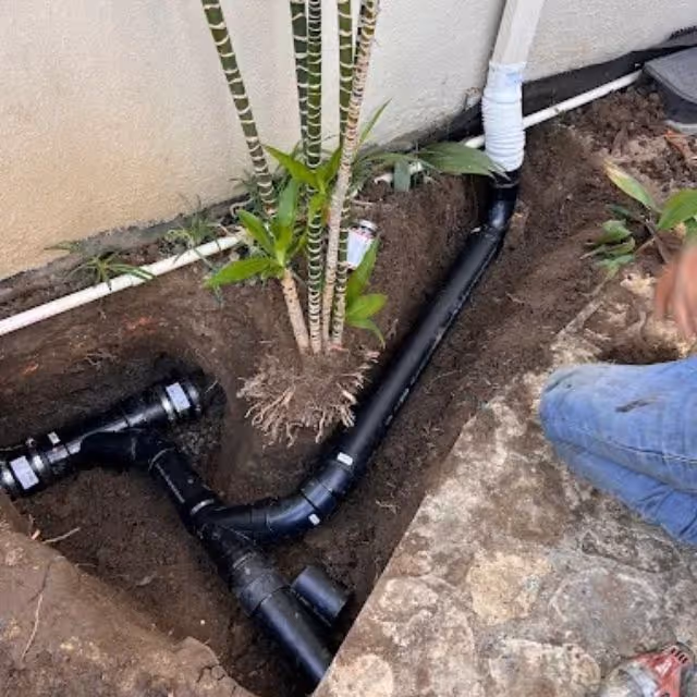 New ABS sewer line installed in residential trench near foundation.