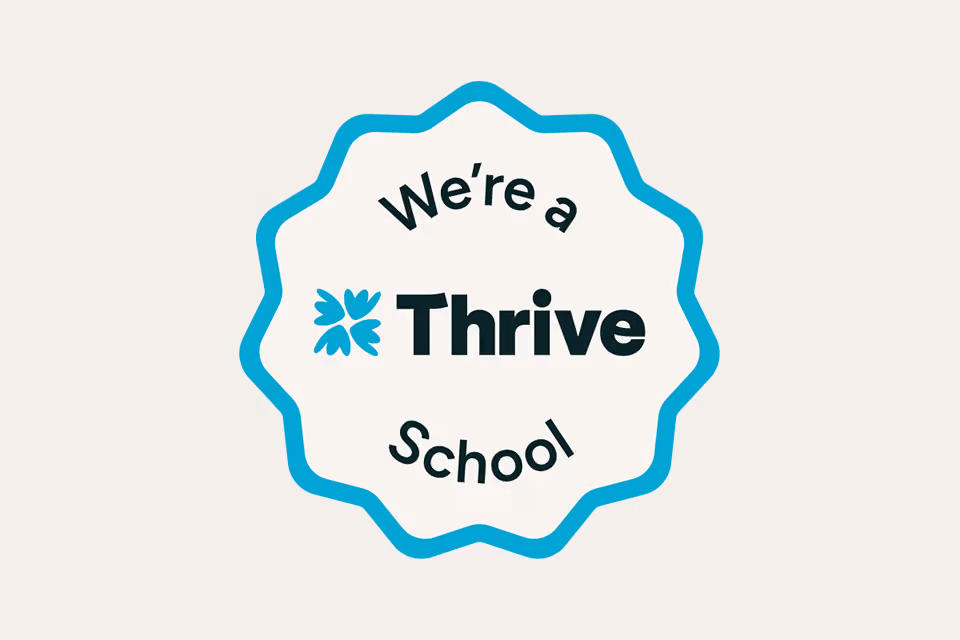 Badge with text 'We're a Thrive School' and a four-leaf clover icon.