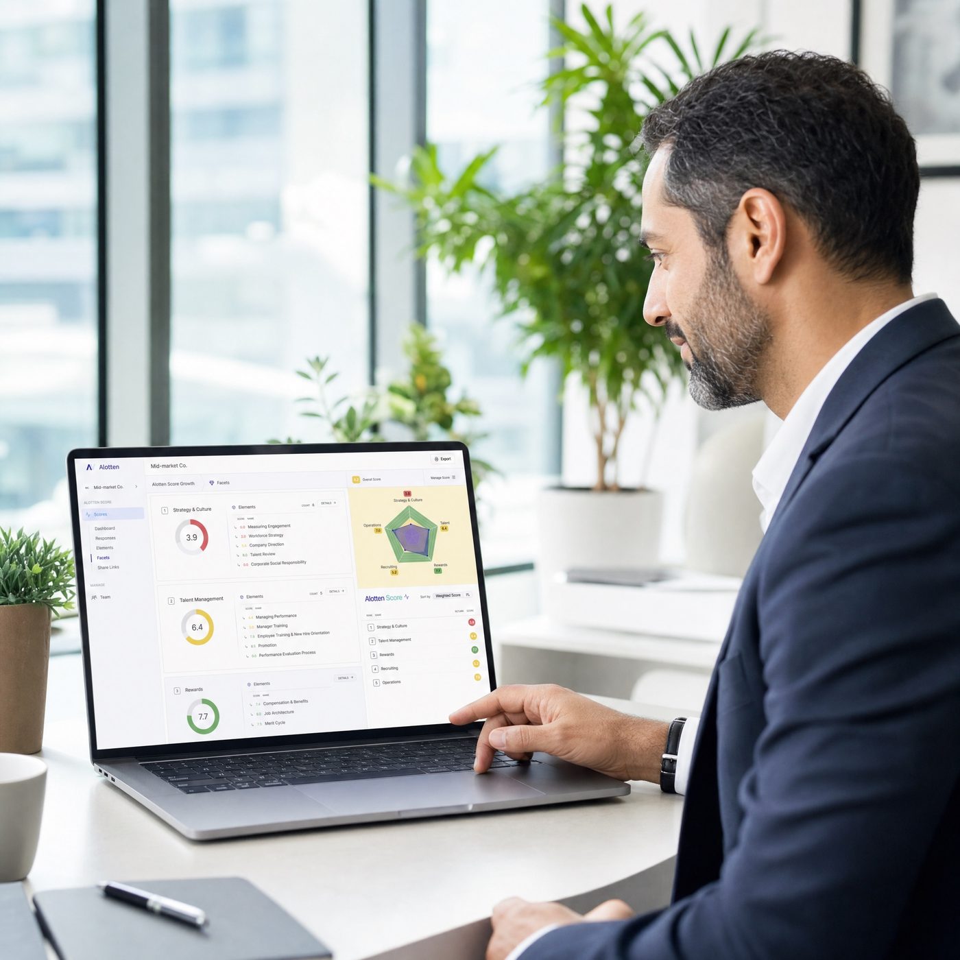 Consultant assessing HR performance data on a laptop