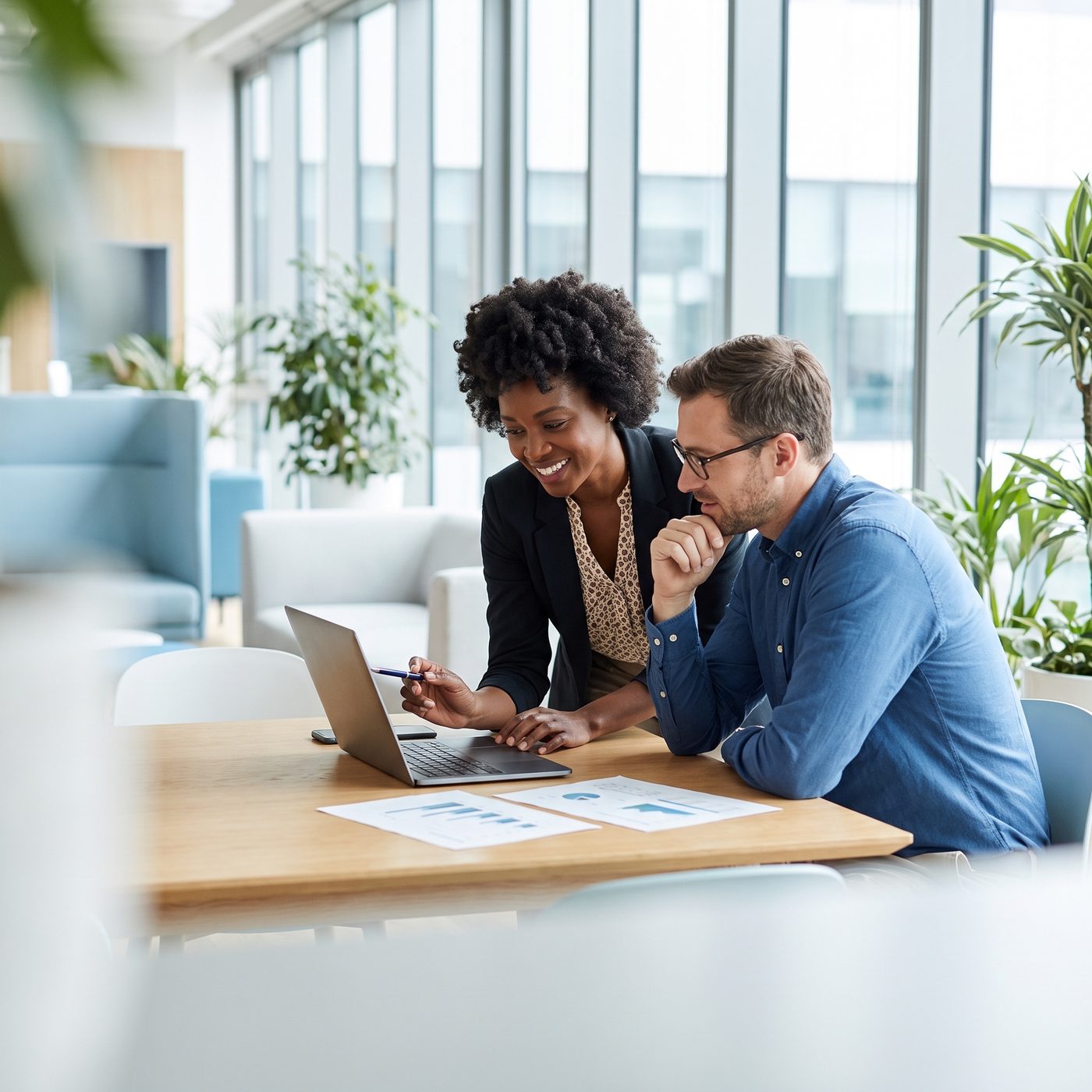 Two colleagues aligning on an HR action plan around a table
