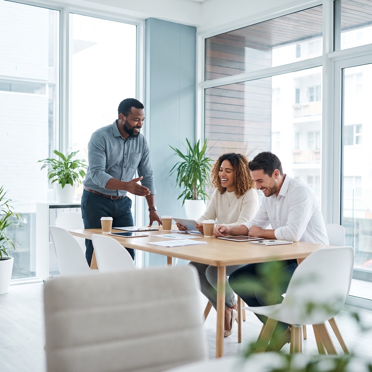 A manager leading a small team working session around a table