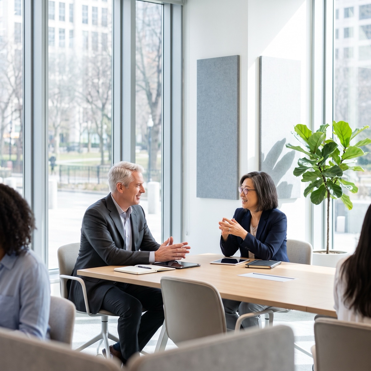 Senior colleagues in a facilitated discussion around a meeting table