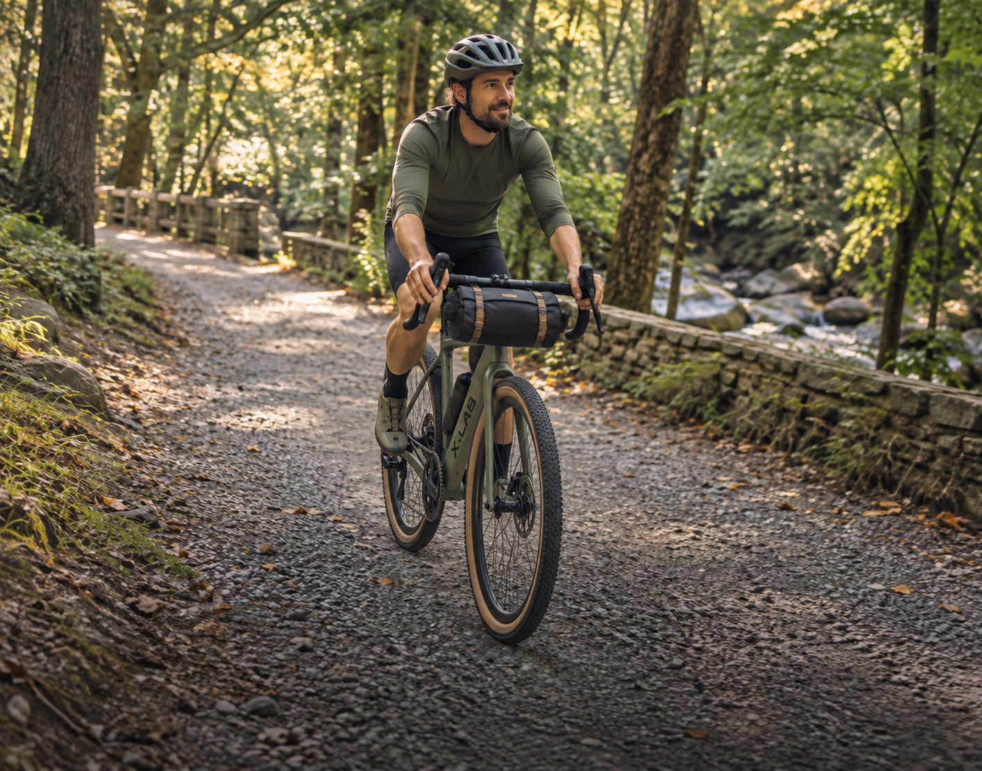 Cyclist on a gravel bike with bikepacking bag on a crushed stone path