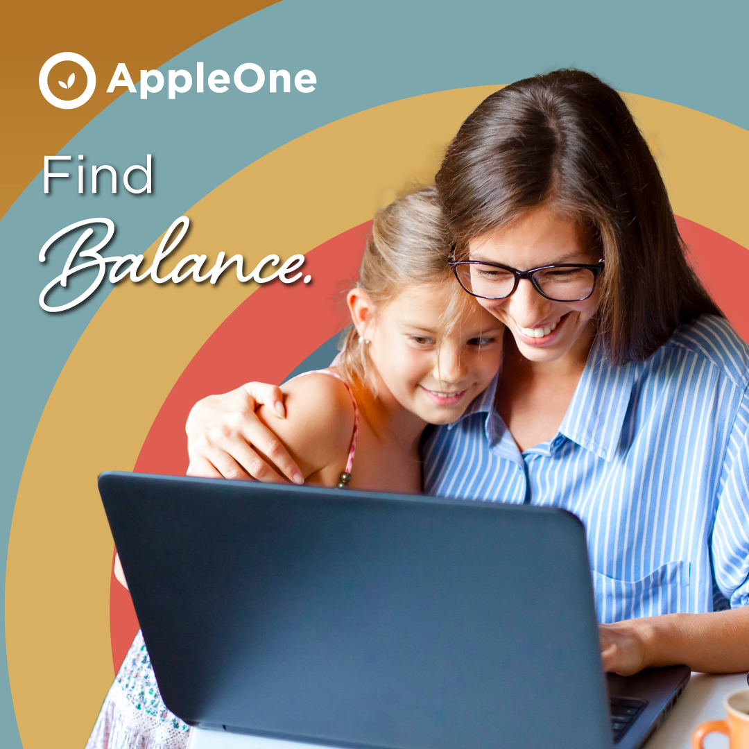 A woman holding her daughter while looking at a laptop. The text reads "Find Balance."