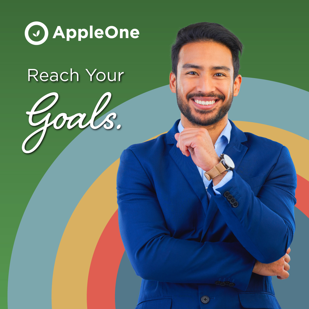 A man in a blue suit smiling. The text reads "Reach Your Goals."
