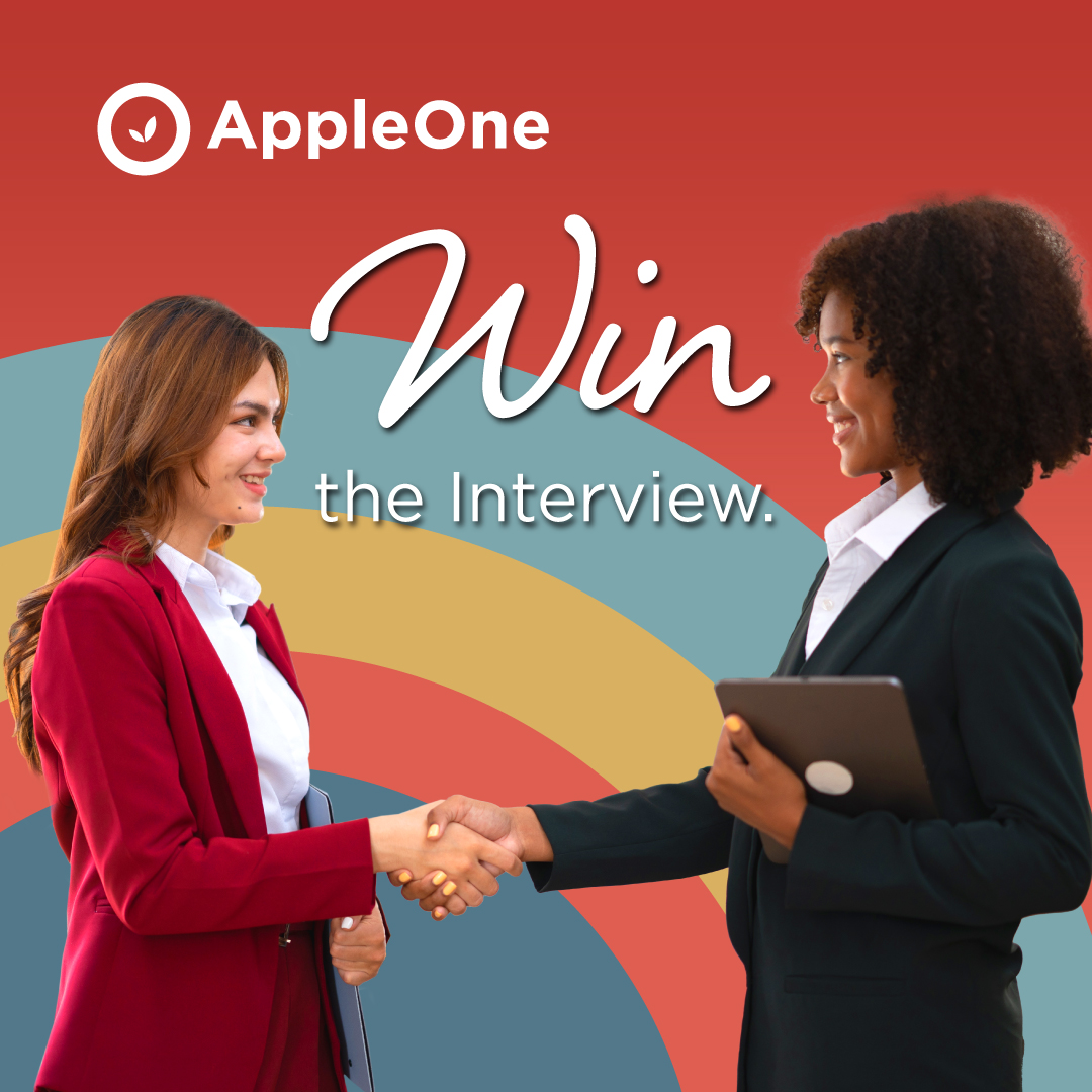 Two professional women shaking hands with each other. The text reads "Win the Interview."