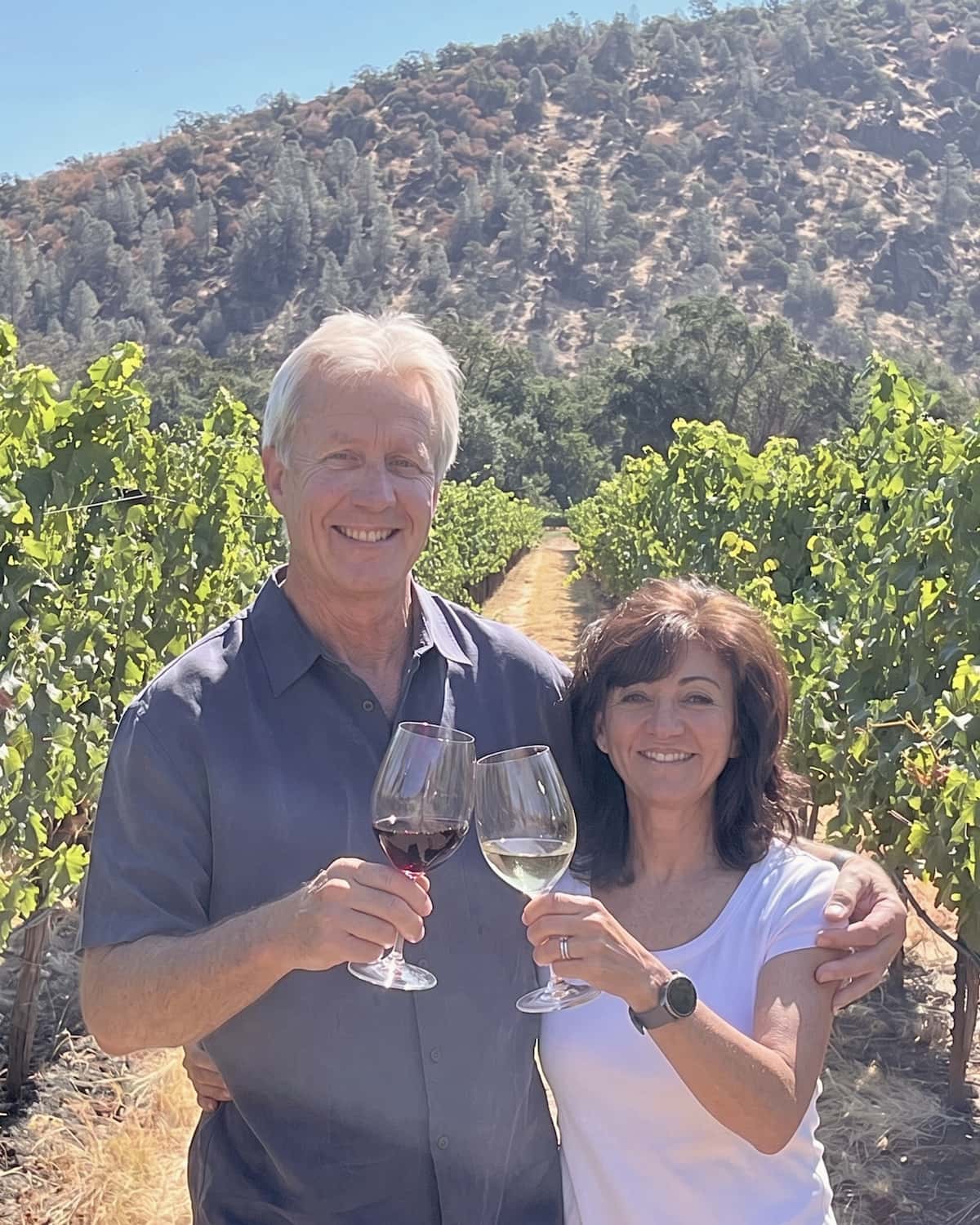 Andreas and Sally with wine glasses in their vineyards