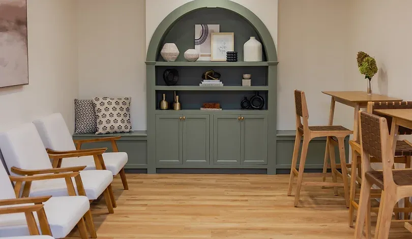 Waiting area at Ridgefield Orthodontics with a green built-in cabinet and wood chairs