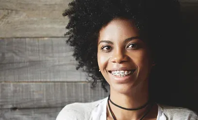 Smiling woman with metal braces