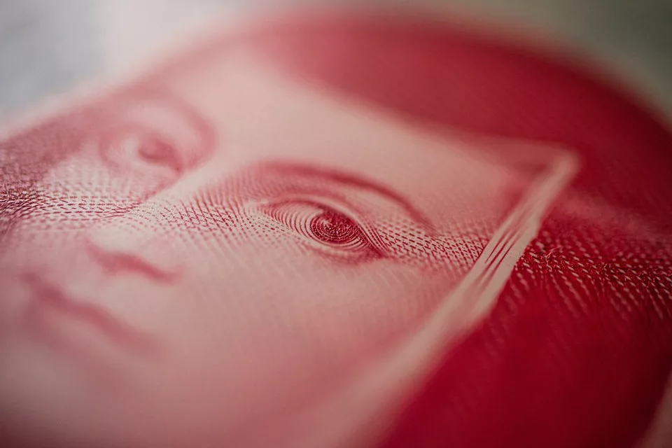 Close-up of a red banknote showing detailed texture and an eye