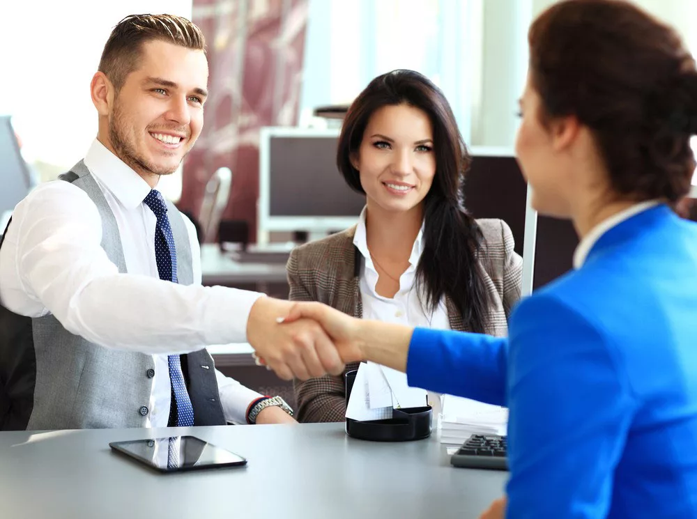 Business professionals shaking hands in an office